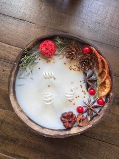 a bowl filled with milk and fruit on top of a wooden table