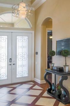 a foyer with two doors and a checkered floor