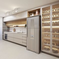 a refrigerator freezer sitting inside of a kitchen next to a counter top oven and dishwasher