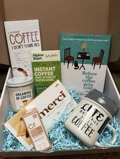 an open box containing coffee, books and other items to be used as a gift