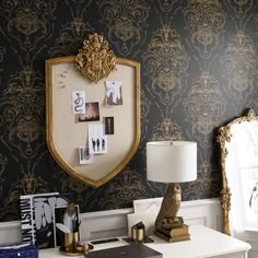 a white desk topped with a lamp next to a mirror