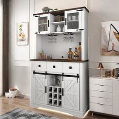 a white cabinet filled with bottles and glasses