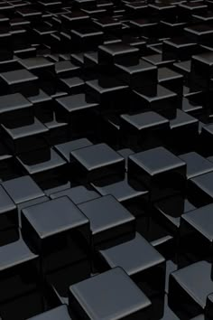 a large group of black square objects in the dark