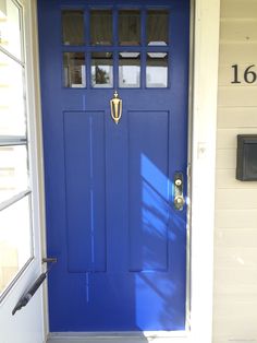 a blue front door with the number 16 on it