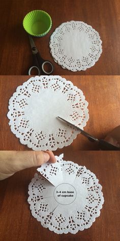 someone cutting paper doily with scissors on a wooden table