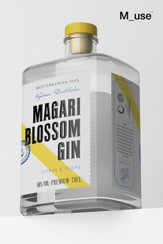 a bottle of magari blossom gin on a white surface with the label below it