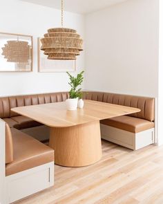 a large wooden table sitting under a chandelier