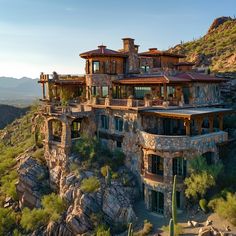 an aerial view of a large house on top of a mountain