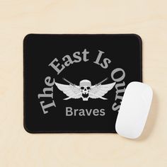 a mouse pad with the words, the east is out and a skull on it