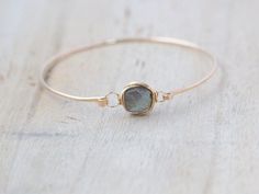 A simple, hammered 14K gold filled bangle features a gorgeous Labradorite faceted cube wrapped in 14k gold filled wire for a bezel look. This cuff has a hinge style clasp to make it easy to put on take off. It looks great worn alone or layered with other bracelets. *** Available in 14k Gold Fill (shown), 14k Rose Gold Fill or Sterling Silver) Bracelet - Choose your perfect fit. 7.5 inches in circumference is the most average size. Labradorite Cube - approx 8mm **** HOW TO FIND YOUR FIT **** - Th Beauty Magic, Girl Stuff, Gemstone Bracelets, Bracelet Stack, Wire Wrap, Gemstone Bracelet, Modern Jewelry, Artisan Jewelry, Wire Jewelry