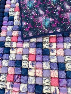 an area rug with many different colored squares and small stars on the top, in various colors