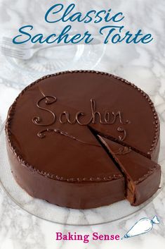 a chocolate cake with the words sacher torte written on it and a piece missing