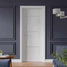 a living room with two chairs and a table in front of the door that leads to another room