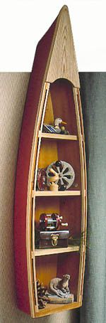 a canoe shaped shelf with various items on it