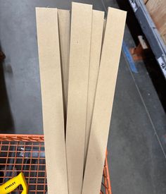 four pieces of brown paper sitting on top of a shopping cart