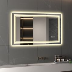 a bathroom sink with a lighted mirror above it