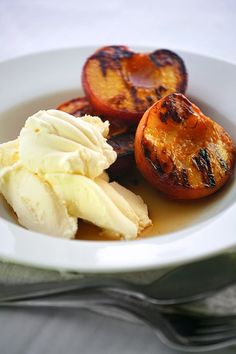 grilled peaches and ice cream in a white bowl