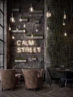 the interior of a restaurant with several chairs and lights hanging from the ceiling above them