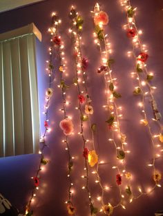 a wall with lights and flowers on it