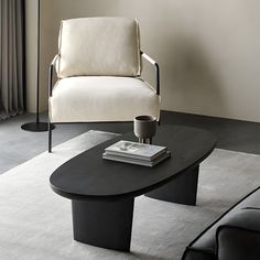 a living room with a couch, chair and coffee table in front of a window