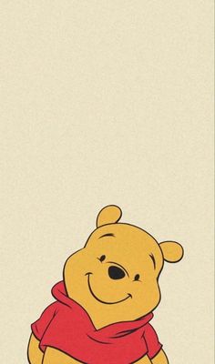 winnie the pooh is sitting down with a scarf around his neck