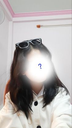 a woman with sunglasses on her head and a question mark in the middle of her face