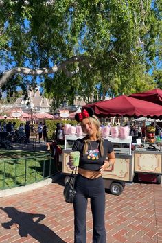 a woman standing in front of an ice cream stand