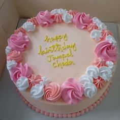 a birthday cake with pink and white frosting