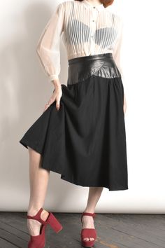 Vintage 1980s Dress / 80s Wool Skirt with Leather Waistband / Black ( small S ) ~T H E R U N D O W N~ Modern Size: S Materials: Wool and leather Condition: Excellent vintage condition Brand: None listed ~F U L L D E T A I L S~ Chic '80s skirt done in black wool with a wide leather waistband. High banded waist, full shape, and midi cut. Very flattering! Zipper and button closure at the back, fully lined. ~ M E A S U R E M E N T S~ Waist: 27 inches around Hips: Free Length Shoulder to Hem: 31 inches ♥ More vintage skirts https://www.etsy.com/shop/lapoubellevintage?section_id=6491957 ♥ More vintage clothing http://www.etsy.com/shop/lapoubellevintage Instagram: lapoubellevintage Twitter: @poubellevintage Facebook: La Poubelle Vintage International buyers: Please note that your order may be sub 80s Skirt, 1980s Dresses, 80s Dress, F U, Vintage Rock, Wool Skirt, Wool Skirts, Vintage Skirt, Black Wool