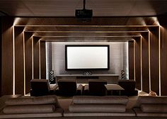 a large room with couches and a flat screen tv on the wall in it