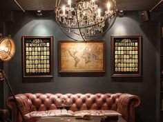 a living room filled with furniture and a chandelier hanging from the ceiling over a table