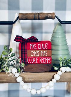 a wooden sign that says mrs claus's christmas cookie recipes on top of a shelf