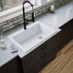 a white sink sitting on top of a counter next to a window