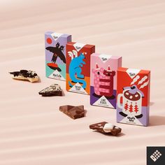 several colorful boxes with different types of chocolates on the floor next to each other