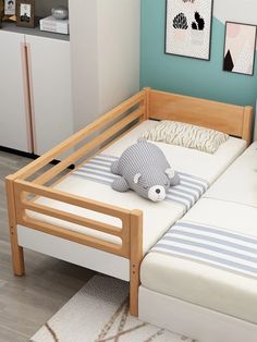 there is a small bed with two pillows on it and a stuffed animal in the middle