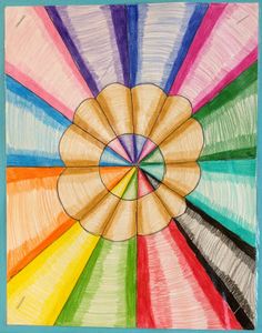 an art project with colored pencils in the shape of a rainbow wheel on a blue background