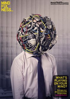 a man wearing a tie with lots of wires on his head in front of him