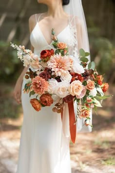 a bride holding a bouquet of flowers in her hand