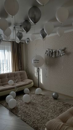 balloons are floating in the air near a couch