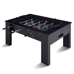 the foosball table is black with red, white and blue pins