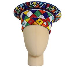 This elegant Zulu Beaded Basket Hat with multicolored checkered pattern is the perfect accessory to upgrade any outfit. This piece is handmade by female artisans in South Africa. The hat is made out of woven grass, polyester cloth patterned with cotton, wool threads, and decorative glass beads. It can be worn on special occasions like birthdays, weddings, and formal gatherings. As with all handmade items, no two pieces are the same. Measurements: 21" Circumference Zulu Head Gear, Zulu Attire, Basket Hat, Beaded Basket, African American Clothing, Black Nativity, Beaded Gloves, African Hats, Traditional Weddings