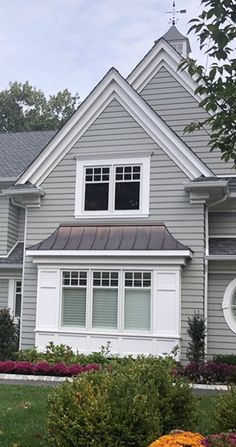 a gray house with white trim and windows