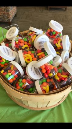 a basket filled with lots of different types of candies on top of a table