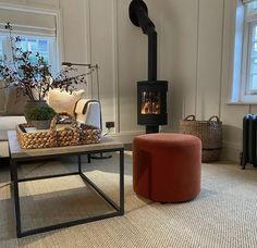 a living room filled with furniture and a fire place in the middle of the room