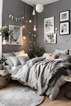 a bedroom with grey walls and pictures on the wall, lights hanging from the ceiling