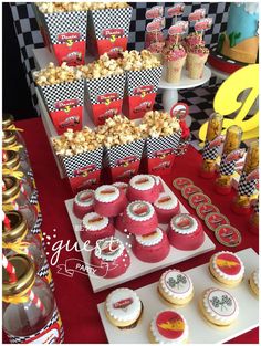 a table with many cupcakes and snacks on it