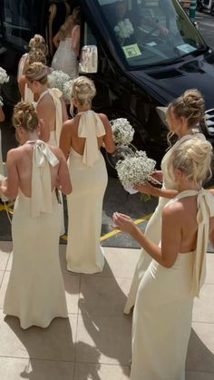 the bridesmaids are getting ready to get into their limo