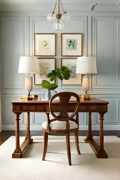 a desk with two lamps and some pictures on the wall