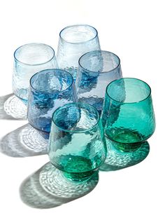 several blue glass cups sitting next to each other