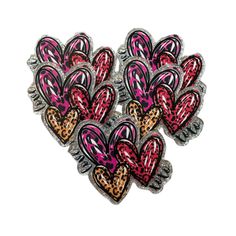 leopard print heart shaped pin with pink, black and red hearts in the center on a white background